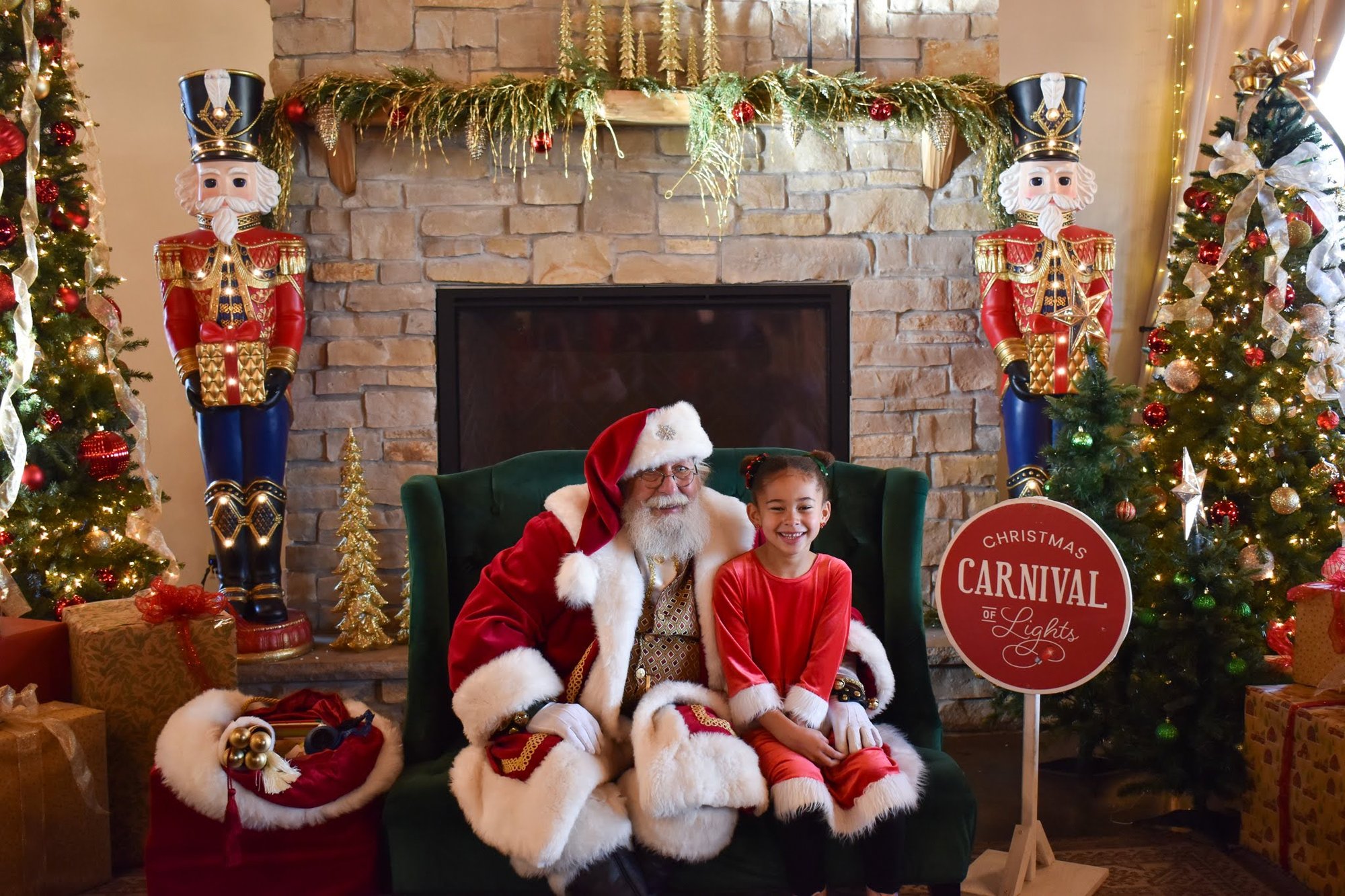 Girl taking a picture with Santa in Santas Workshop at the Christmas Carnival of Lights Girl taking a picture with Santa in Santas Workshop at the Christmas Carnival of Lights
