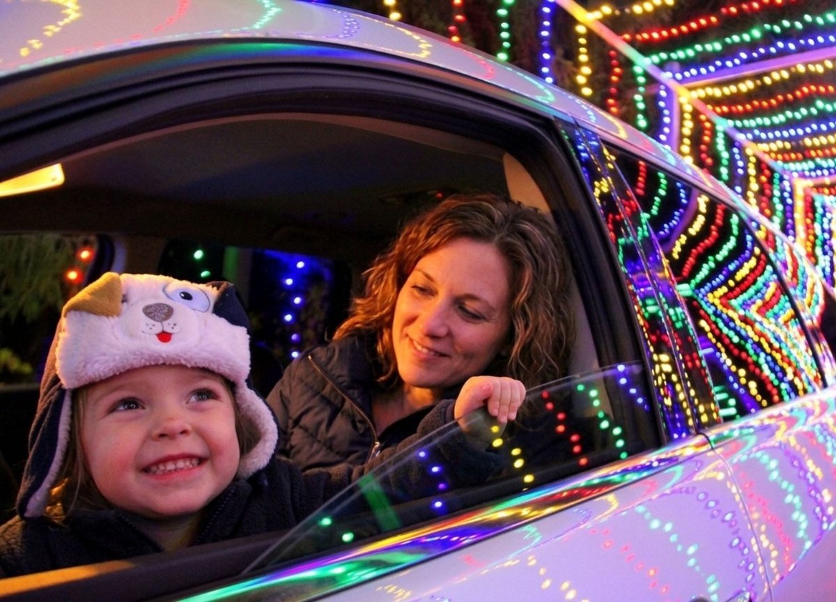 Mother & child driving through the Christmas Carnival of Lights light show and admiring all the dazzling lights Mother & child driving through the Christmas Carnival of Lights light show and admiring all the dazzling lights
