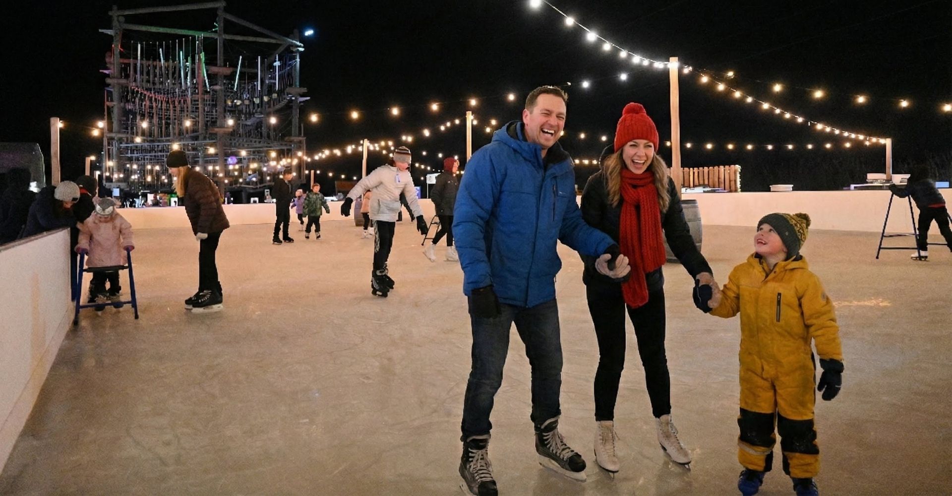 Family skating under the lights on the outdoor ice skating rink at the Christmas Carnival of Lights Family skating under the lights on the outdoor ice skating rink at the Christmas Carnival of Lights