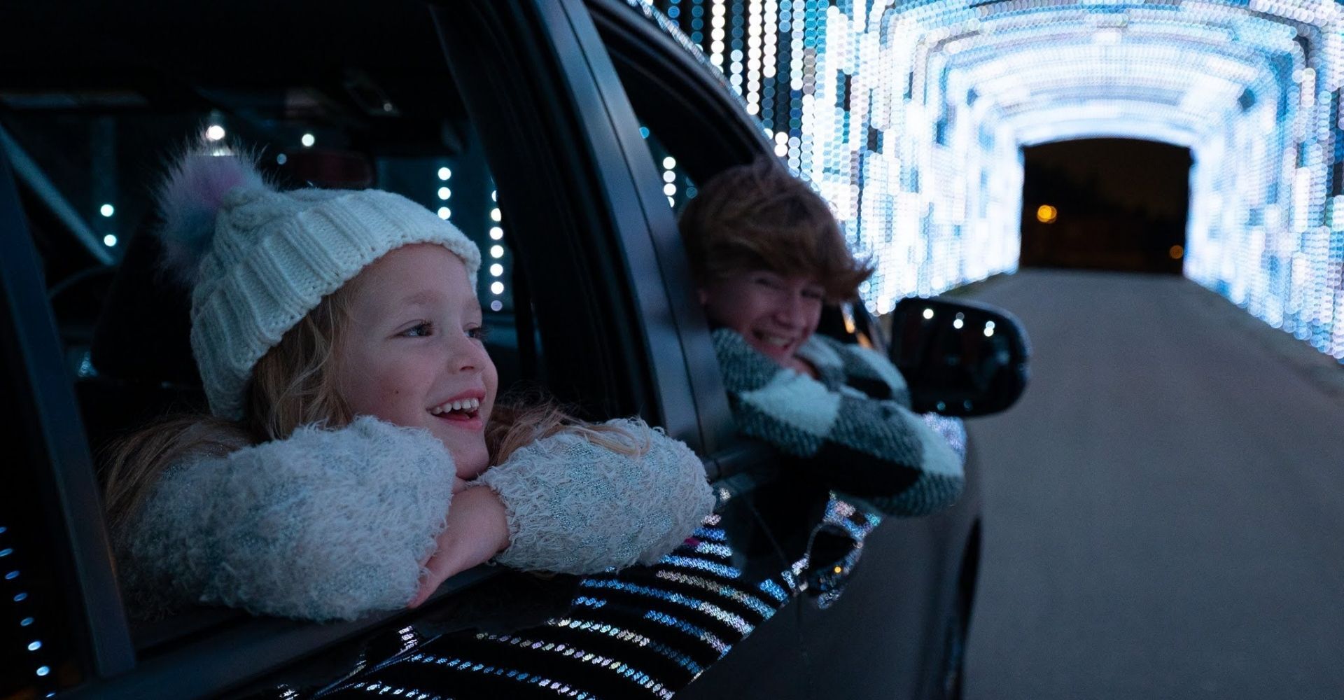 kids smiling during the christmas carnival of lights drive through light show kids smiling during the christmas carnival of lights drive through light show